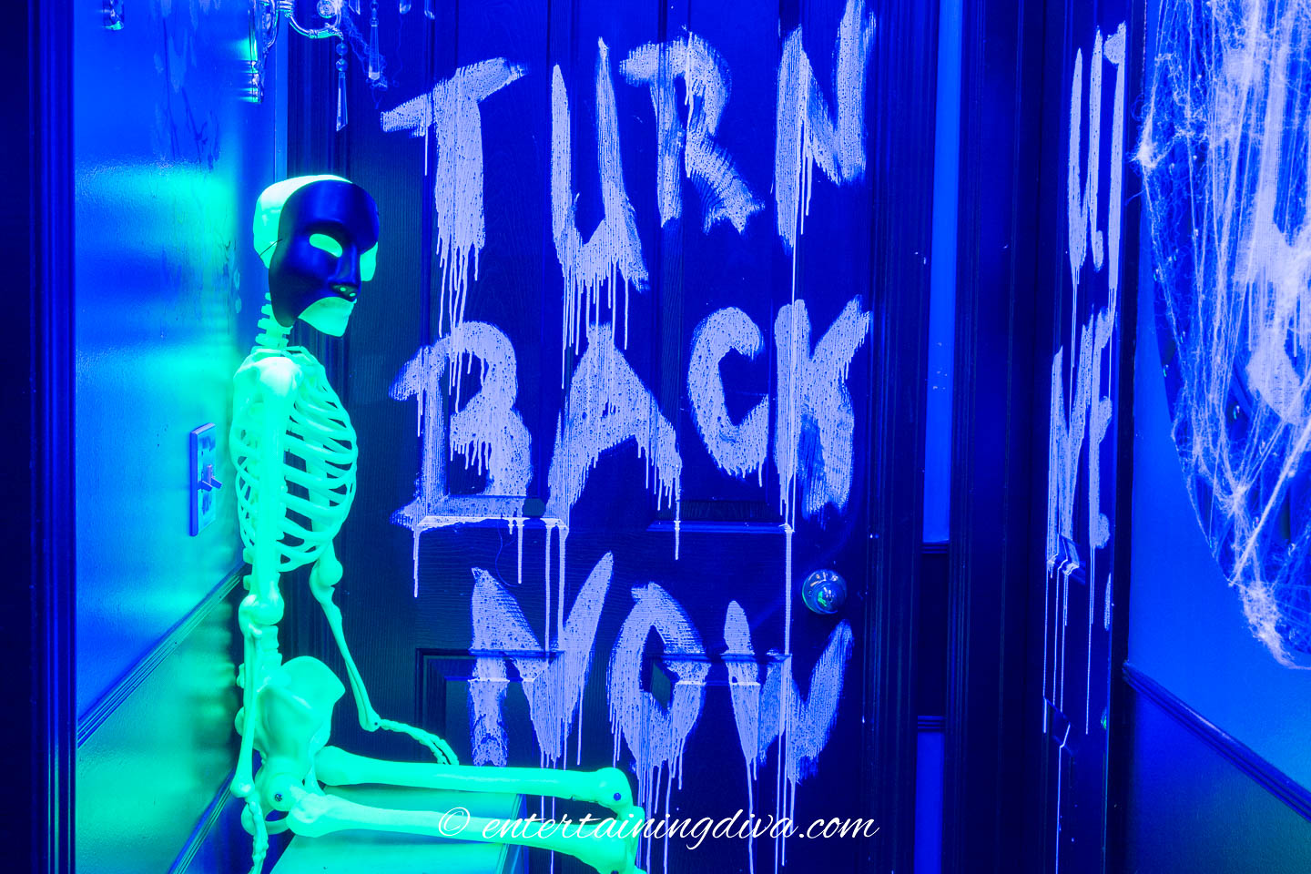 Glow in the dark skeleton and writing on the wall at a Halloween party