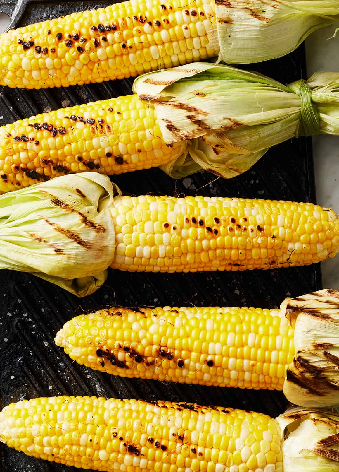 Grilled corn on hot grill grates