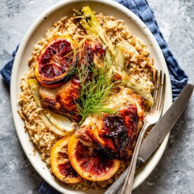 Citrusy Baked Orange Chicken Thighs over rice, a unique dinner idea for two.