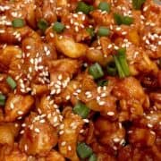 Gochujang chicken stir fry with spring onions and sesame seeds.
