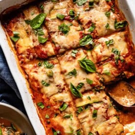 A cheesy, bubbling zucchini lasagna with fresh basil, an easy dinner idea for couples looking for a lighter meal.